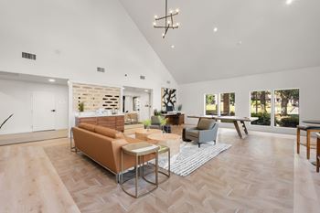 A living room with a couch, chairs, and a coffee table.